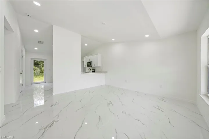 Spare room featuring lofted ceiling