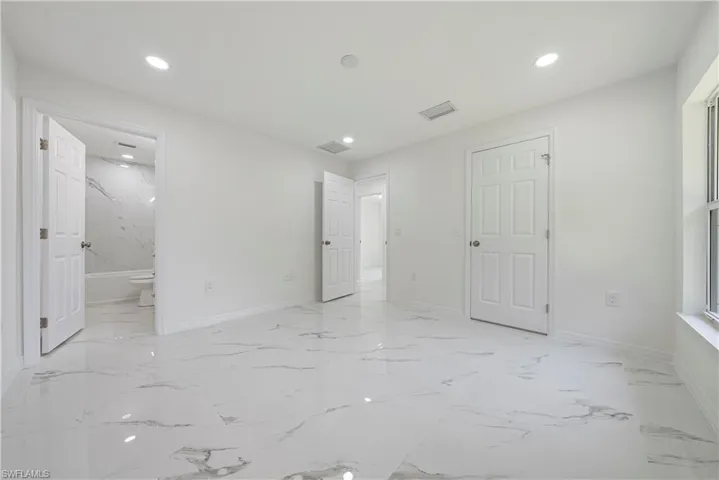 Unfurnished bedroom featuring ensuite bath