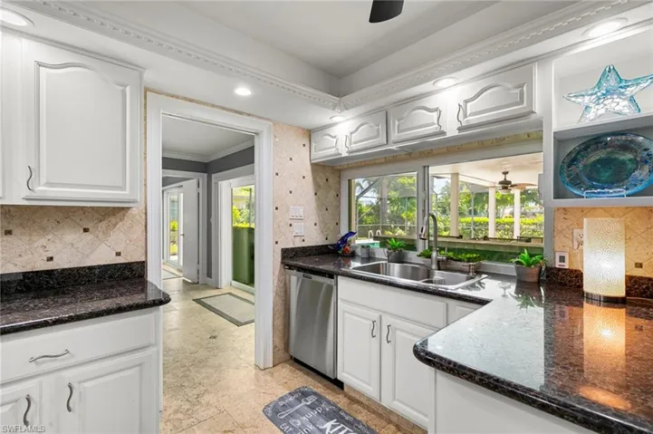 Kitchen featuring stainless steel dishwasher, a ceiling fan, white cabinets, crown molding, and recessed lighting
