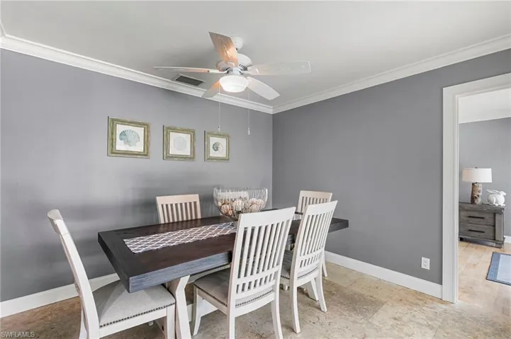 Dining area featuring crown molding and a ceiling fan