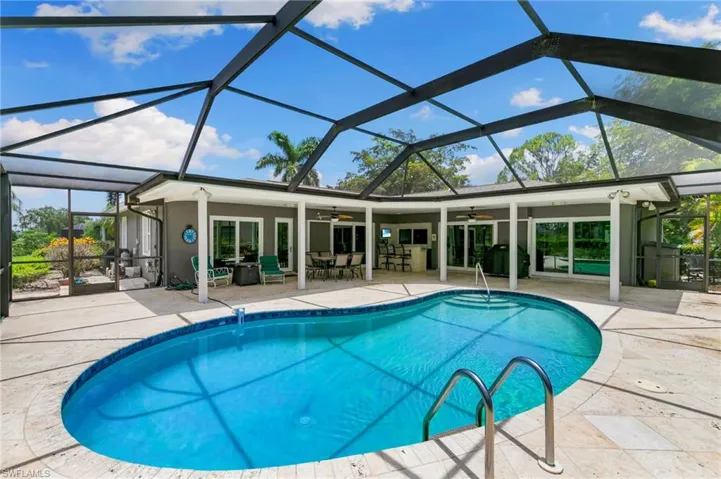 Outdoor pool with ceiling fan, a patio, a lanai, and a grill