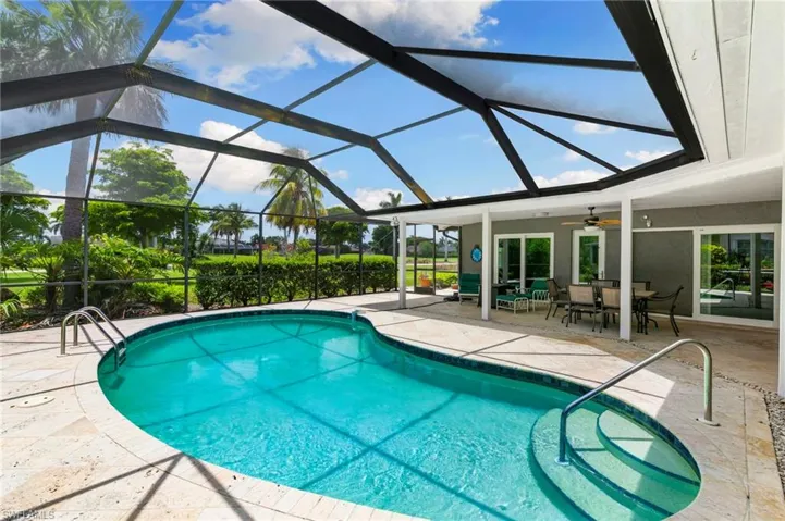 Outdoor pool with a patio area, ceiling fan, and outdoor dining space