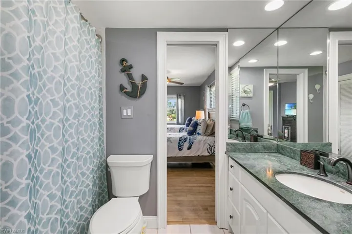 Full bath with ensuite bathroom, vanity, recessed lighting, a ceiling fan, and tile patterned floors