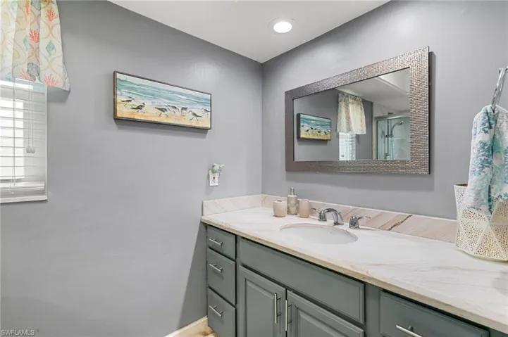 Bathroom with vanity and an enclosed shower