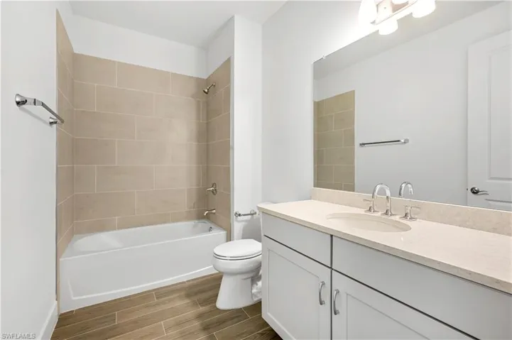 Guest bathroom with quartz countertops and shower tub