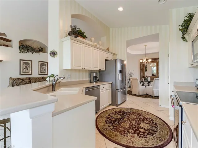 White cabinets and Corian countertops.  Wall accent is faux paint , not wallpaper