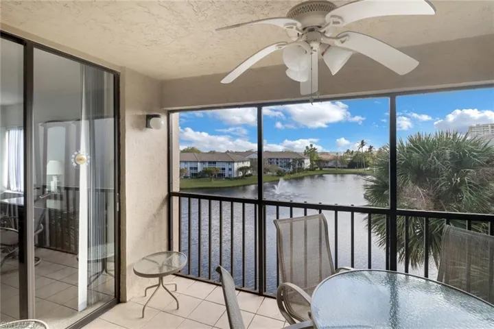Sunroom / solarium featuring a water view, a healthy amount of sunlight, and ceiling fan
