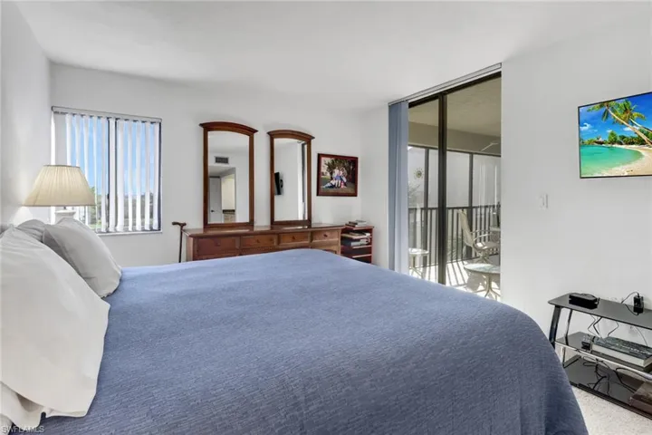 Carpeted bedroom featuring access to outside