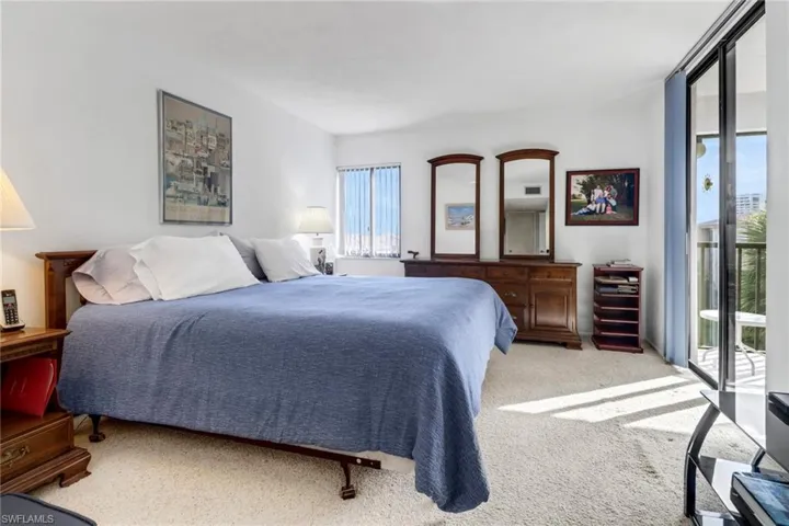 Carpeted dining space featuring a notable chandelier and sink