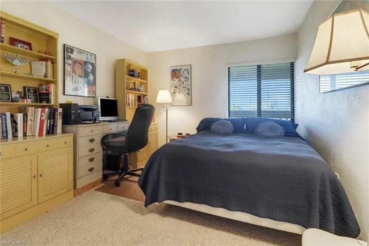 Bedroom featuring light colored carpet