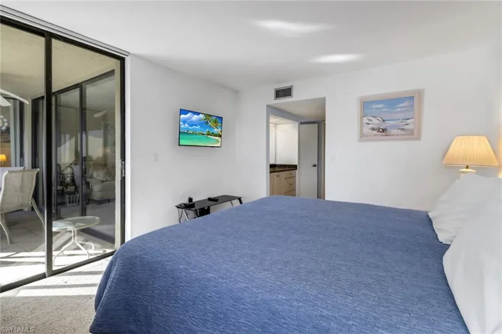 Carpeted bedroom with access to exterior