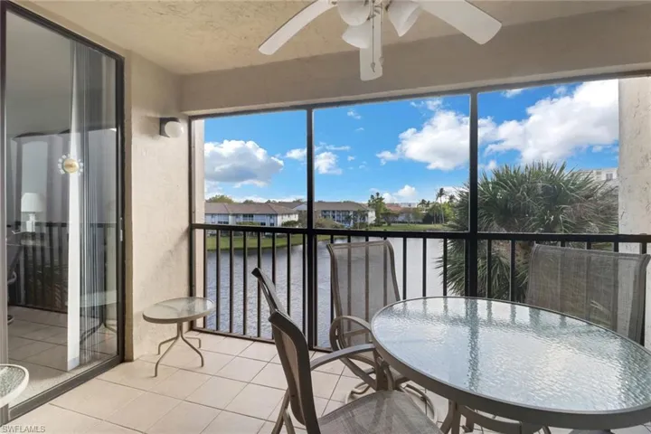 Sunroom featuring a water view and ceiling fan