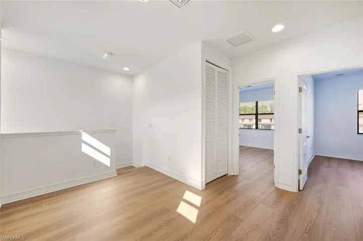 Spare room with light wood finished floors and recessed lighting