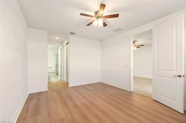 Spare room with ceiling fan, light wood-style flooring, and recessed lighting