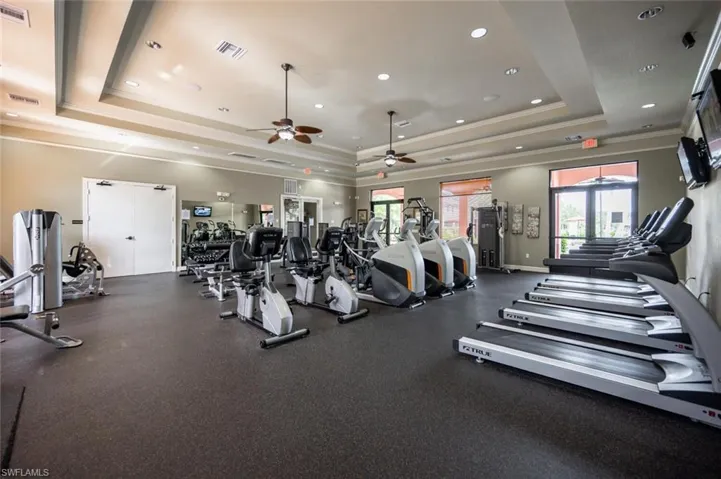 Exercise room with ceiling fan, crown molding, and recessed lighting