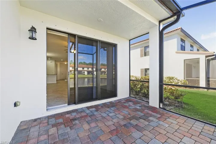 Property entrance featuring stucco siding and a sunroom