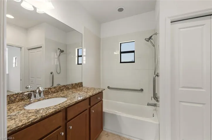 Full bath featuring vanity, shower / washtub combination, and a closet