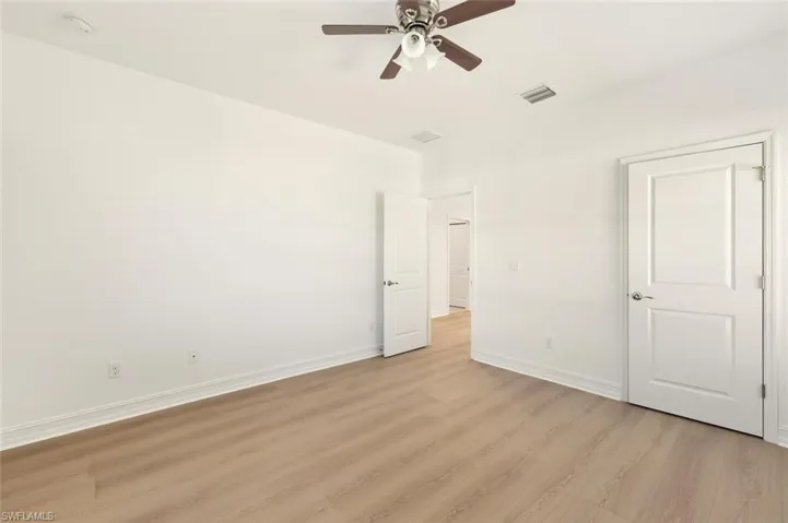 Unfurnished bedroom with light wood finished floors and a ceiling fan