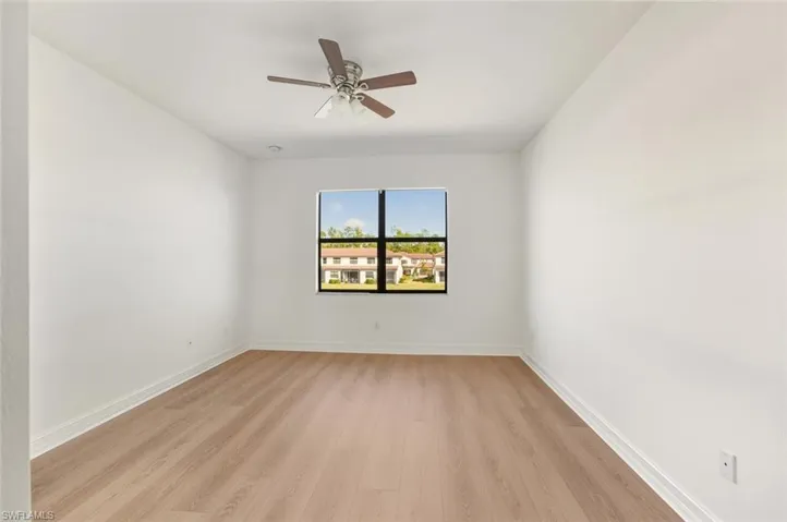 Spare room featuring light wood-style flooring and ceiling fan