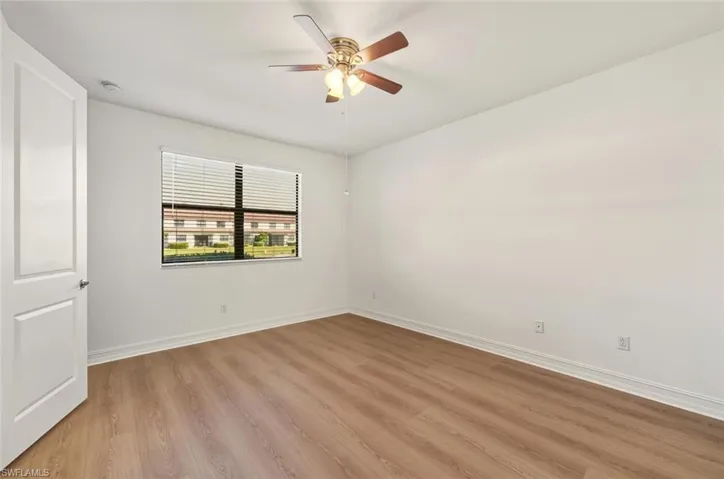 Empty room with light wood-style flooring and a ceiling fan