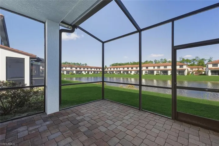 Unfurnished sunroom featuring a water view