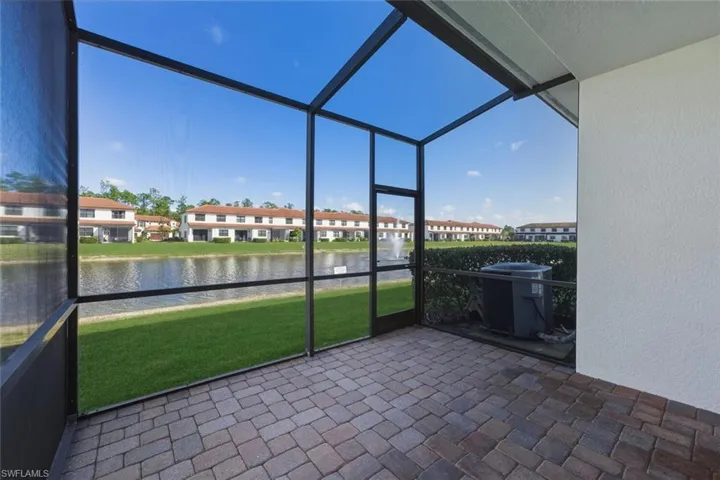 Unfurnished sunroom with a water view