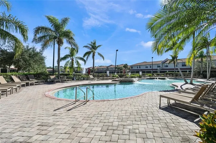 Community pool with a patio and a residential view