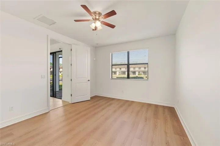 Spare room featuring light wood-type flooring and a ceiling fan