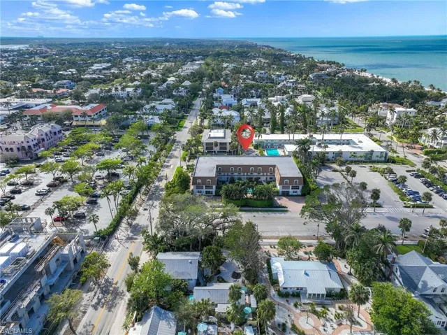 Aerial view of property and surrounding area featuring a large body of water