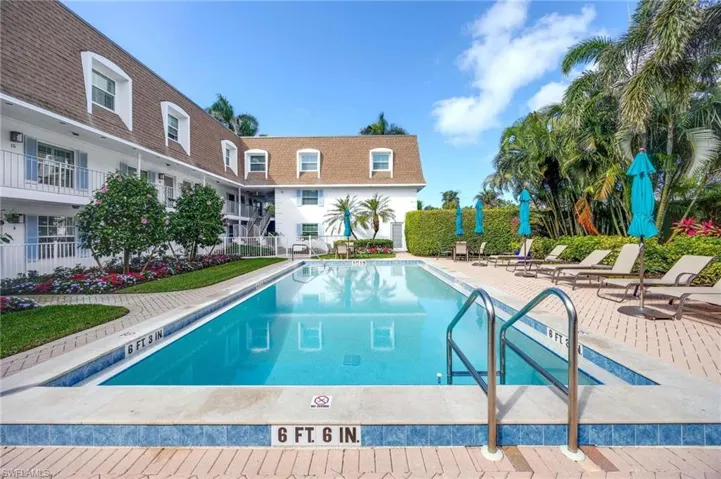 Community pool with a patio
