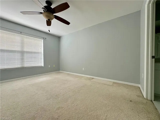 Spare room with carpet and ceiling fan