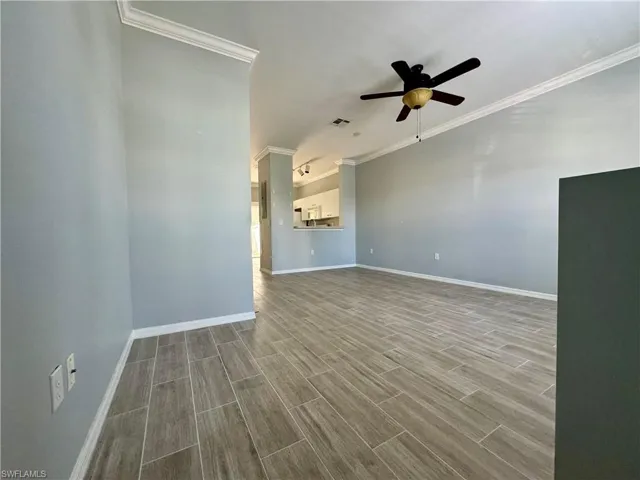 Spare room featuring ceiling fan, ornamental molding, and hardwood / wood-style floors