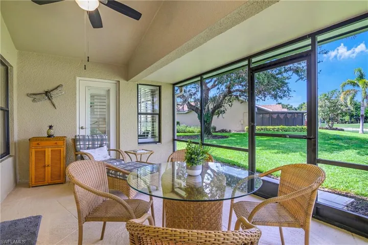Sunroom featuring a ceiling fan, healthy amount of natural light, vaulted ceiling, and outdoor dining area