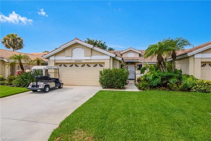 View of front of property with a tiled roof, stucco siding, a garage, driveway, and a front lawn