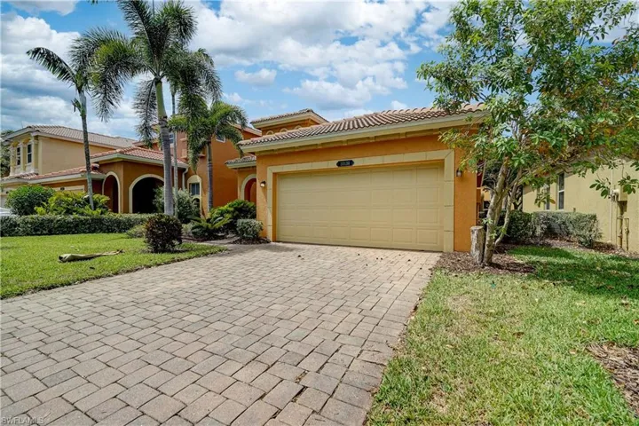 Mediterranean / spanish-style home with a front yard and a garage