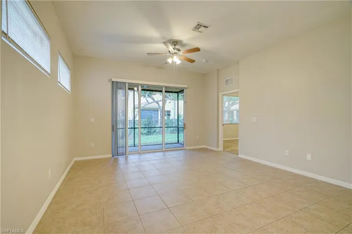 Unfurnished room featuring ceiling fan and light tile flooring