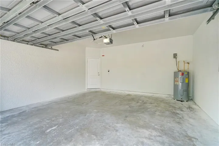 Garage with a garage door opener and electric water heater