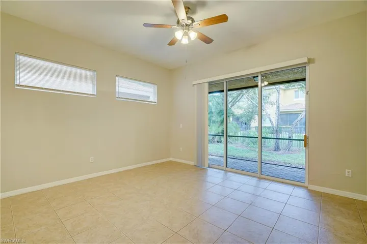 Unfurnished room featuring ceiling fan and light tile floors