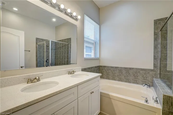Bathroom with dual bowl vanity and separate shower and tub