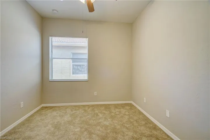 Unfurnished room featuring carpet flooring, plenty of natural light, and ceiling fan