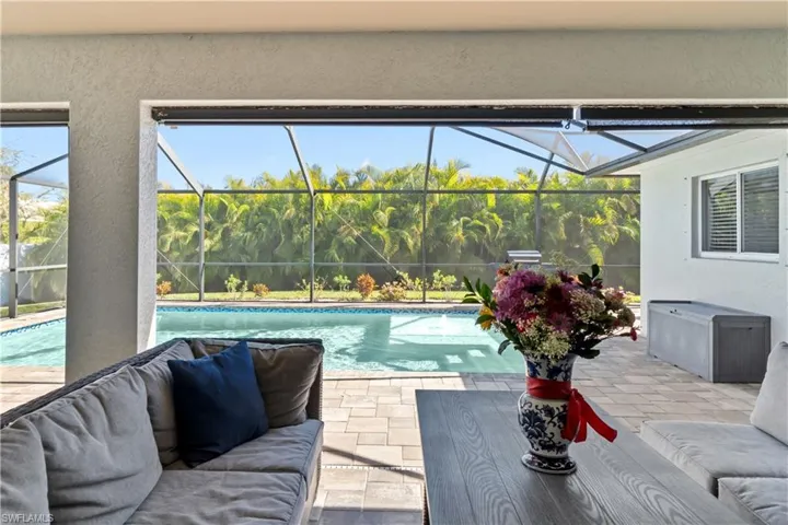 Swimming pool featuring a sunroom, a patio area, a lanai, and outdoor lounge area