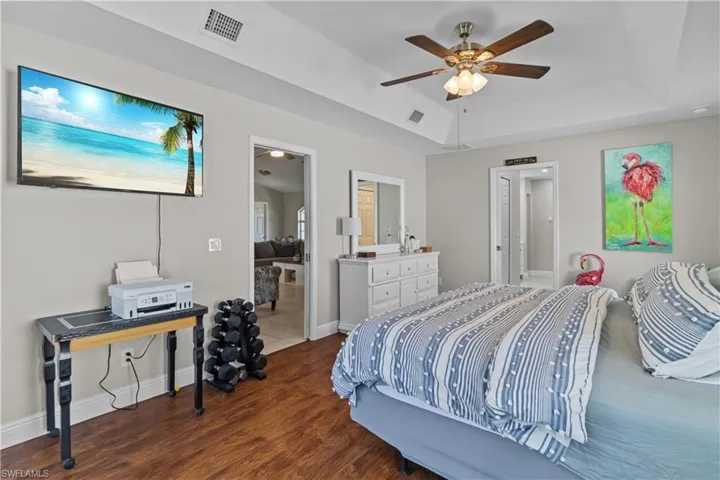 Bedroom featuring dark wood-style flooring and a ceiling fan