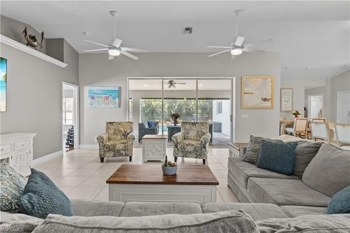 Living area with light tile patterned floors and lofted ceiling