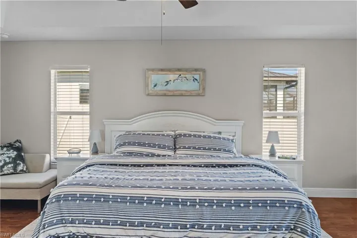 Bedroom featuring dark wood-type flooring and a ceiling fan