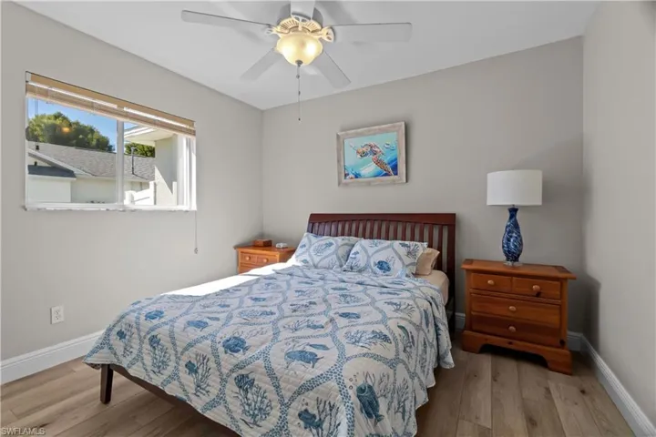 Bedroom with light wood finished floors and ceiling fan
