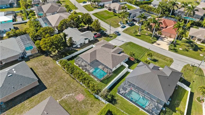 Aerial perspective of suburban area featuring a pool