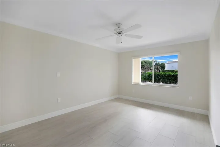 Empty room with crown molding and ceiling fan