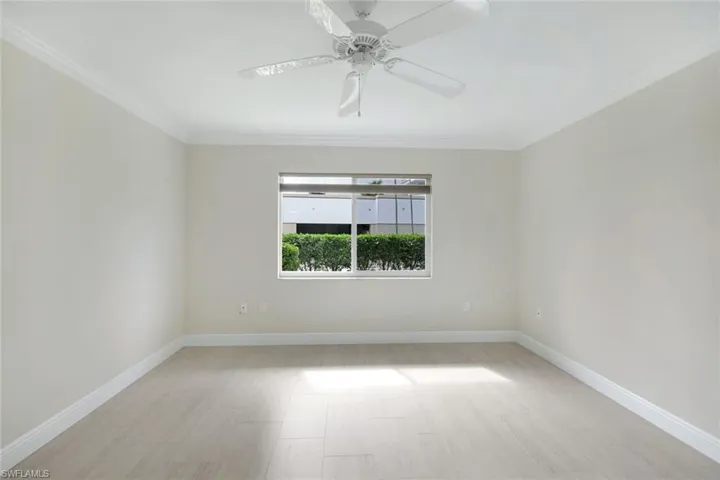 Spare room with crown molding and ceiling fan