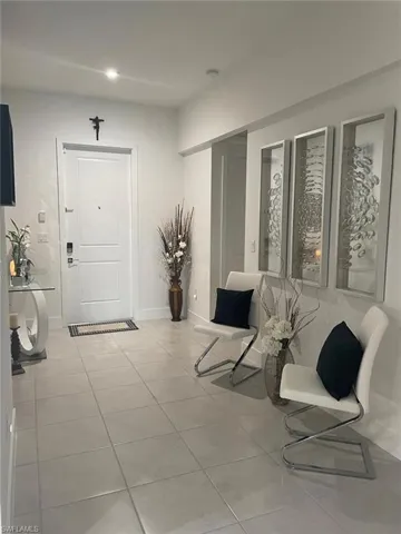 Entrance foyer featuring light tile patterned floors and recessed lighting