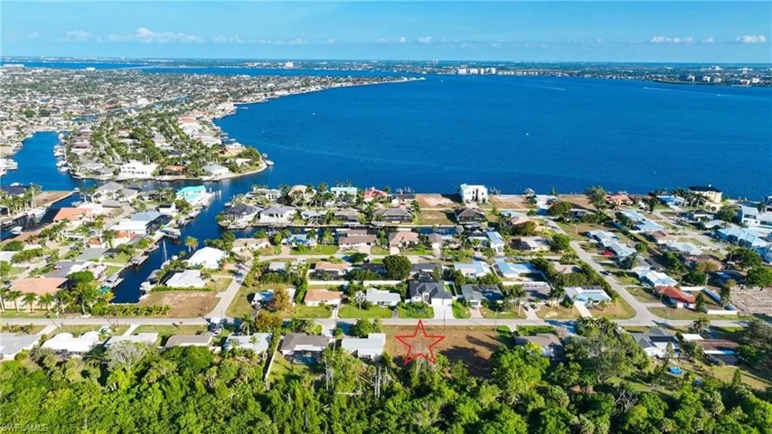 Aerial perspective of suburban area featuring a large body of water